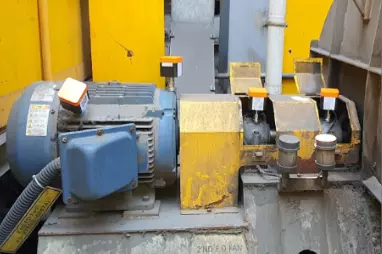 Industrial blue motor and yellow pump assembly with vibration sensors for predictive maintenance monitoring to detect lubrication issues, bearing wear, and imbalance in critical rotating equipment